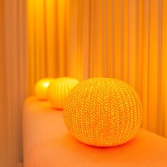 Warm Yellow Knitted Ball Lamps on Orange Surface