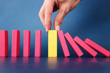 stopping the domino effect. executive and risk control concept