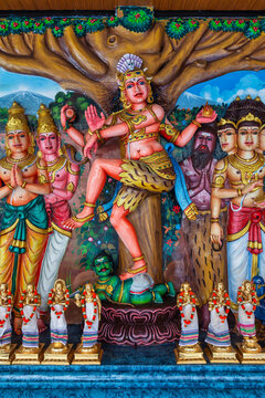 Kuala Lumpur, Malaysia - Feb. 16, 2025: Colorful Hindu deity sculpture of Shiva Nataraja dancing on Apasmara, surrounded by other gods, at Sri Maha Mariamman Temple, Malaysia. Intricate religious art