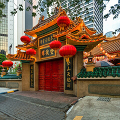 Ornate entrance of Kun Yam Thong Temple, adorned with red lanterns and traditional Chinese...