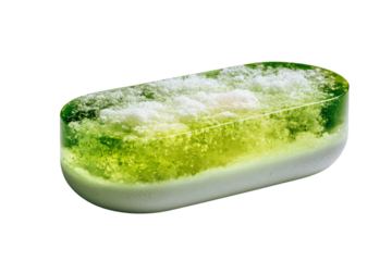 A single oblong translucent green and yellow hard candy.