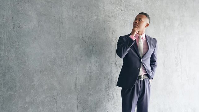 Black male businessman standing in a dark room