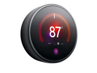 Round, wall-mounted smart thermostat displaying 87 degrees, with a sleek black finish