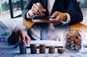 Businessman and team analyzing financial statement Finance task. with smart phone and laptop and tablet. Wealth management concept