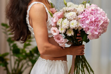 female hands holding bouquet flowers. Gift on the 8 march or valentines day. pink hydrangea