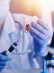 biochemical research scientist team working with microscope for coronavirus vaccine development in pharmaceutical research labolatory, selective focus