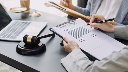 Business and lawyers discussing contract papers with brass scale on desk in office. Law, legal services, advice, justice and law concept picture with film grain effect