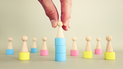 Concept of leadership and forwarding ahead. group of wooden figures and manager