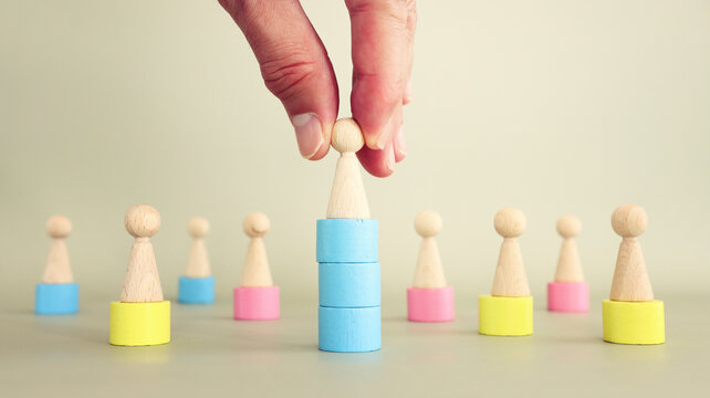 Concept of leadership and forwarding ahead. group of wooden figures and manager