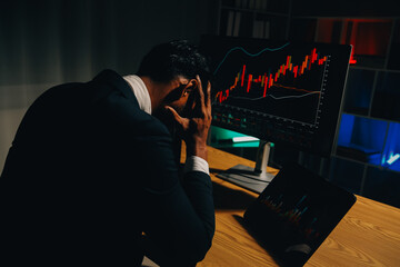 Thoughtful focused successful caucasian male stock investor, broker, financial adviser, sits at work desk, looks at computer, pensively analyze risks and prospects, rise or fall of cryptocurrency coin
