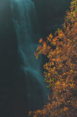 Autumn colors frame Njupeskär waterfall, Sweden's largest, in a stunning natural landscape