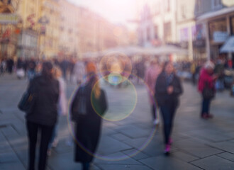 Crowd of anonymous people walking on busy city street	

