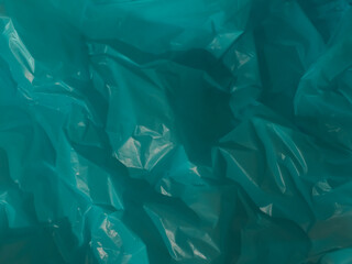 Blue plastic bag texture represents ocean or environment for background.  