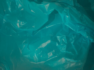 Blue plastic bag texture represents ocean or environment for background.  
