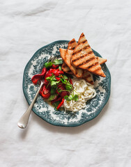 Delicious appetizer, tapas - grilled pickled peppers, stracciatella cheese, coriander, toasts on a light background, top view