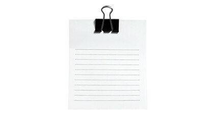 Lined paper held by a black metal clip against a black background