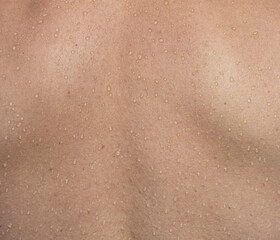 Fototapeta premium A person's back with water droplets on it