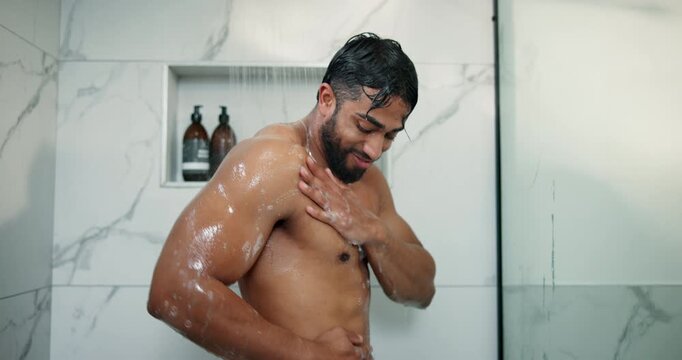 Soap, morning and shower with man in bathroom for body care, skincare routine and water splash. Beauty hygiene, glow and dermatology with person washing in home for cleaning, grooming and hydration