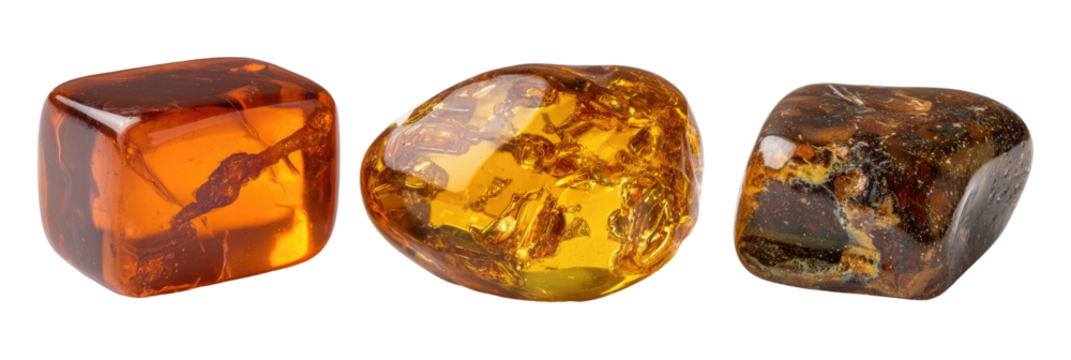 Three polished amber stones, translucent and varied hues