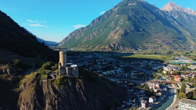 Aerial view of Chateau de la Batiaz in Martigny, with its stone tower perched on a rocky outcrop overlooking the town, Martigny, Valais, Switzerland.