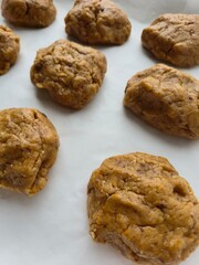 chocolate chip cookies. Homemade raw cookie dough balls ready for baking on parchment paper