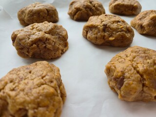 chocolate chip cookies. Homemade raw cookie dough balls ready for baking on parchment paper
