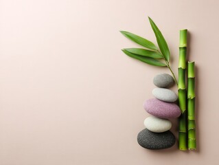 Bamboo leaves and stones on light textured surface, creating zen atmosphere. Minimal design evokes peace and natural harmony.