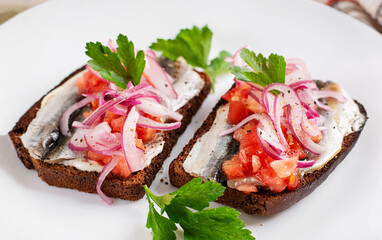 Sandwiches with anchovies, onions, and tomatoes. Diet  food