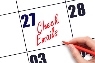27 th day of the month. Hand writing Check emails reminder on calendar with red pen on white...