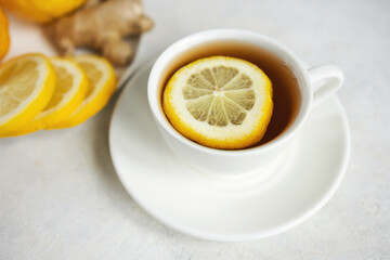 Natural cold and flu remedy with cup of tea, lemon and ginger, health and wellness concept