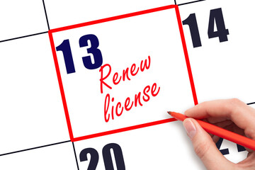 13 th day of the month. Hand writing Renew license reminder and drawing red frame on calendar with red pen on white background. Business concept. Planning and scheduling © Alena