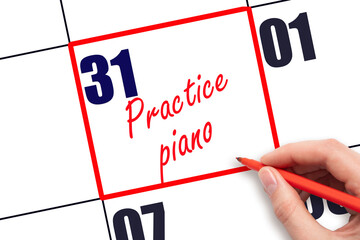 31 st day of the month.  Hand writing Practice piano reminder and drawing red frame on calendar...