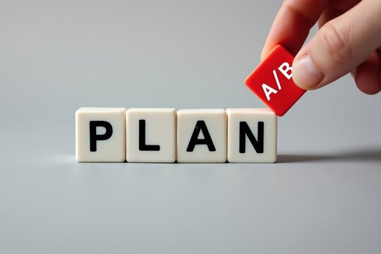 Hand placing red block with A/B onto PLAN blocks, illustrating strategic planning and options