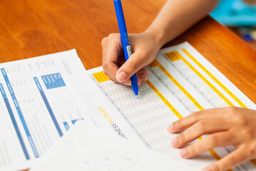 Analyzing financial data sheets home office document review bright environment close-up perspective