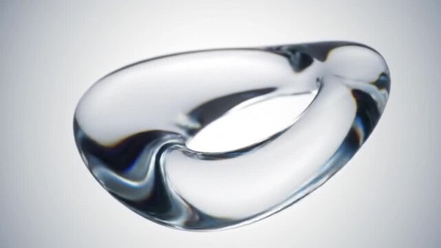 Close up of a clear abstract torus shape with reflections against a gradient white background