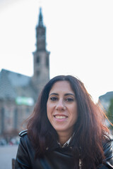 Beautiful woman with long hair black portrayed in Piazza Walther in the historic center of Bolzano,...