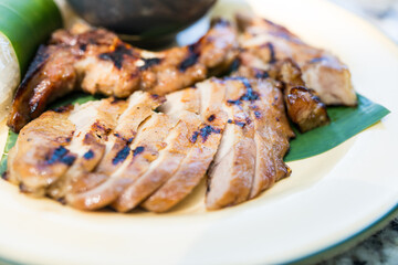 Juicy grilled pork neck cut into bite-sized pieces. Showcasing traditional and flavorful Thai dish