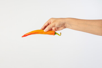 Orange sweet pepper in hand on white background