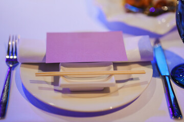 Elegant table setting with chopsticks and folded napkin for dinner event