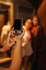 Women enjoying a photography session in a dimly lit venue