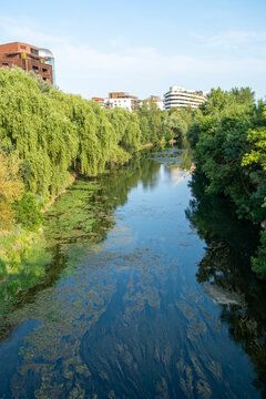 River surrounded by urban greenery in Montpellier, France showing how modern sustainable cities coexist with natural ecosystems and water management