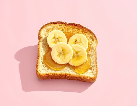 Banana and honey toast, top view, on pastel pink background - Powered by Adobe