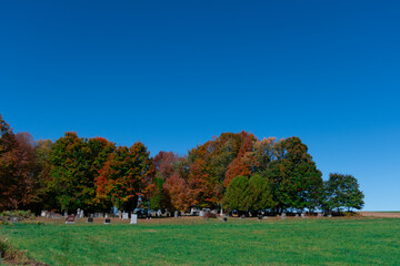View of autumn colors at a cemetery in the Canadian countryside in the province of Quebec