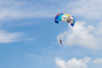Shot of the person doing person doing parasailing activity. Outdoors