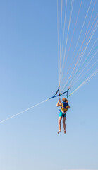 Shot of the person doing person doing parasailing activity. Outdoors