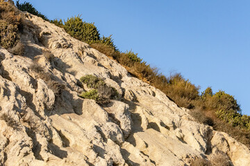 White-weathering, thin bedded, platy siliceous shale. Montery Formation. near Will Rogers State Beach, Santa Monica Bay, at the Pacific coast of Southern California.  Pacific Coast Highway