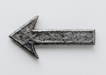 A weathered, gray metal arrow points left