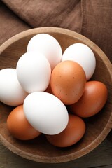 Fresh chicken eggs on wooden table, top view
