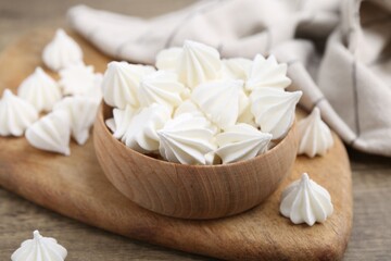 Delicious meringue cookies on wooden table, closeup