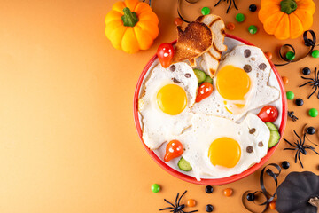 Halloween food, ghost shaped fried eggs, toasts and vegetable salad. Creative homemade lunch or breakfast for Halloween holiday morning